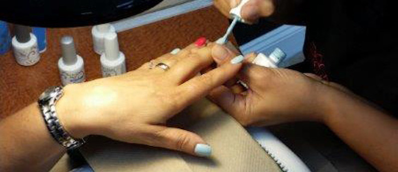 Application of soft gel nail treatment by a nail technician. Nail salon.  Pink gel with glitter. Self employed working from home, authentic situation  Stock Photo - Alamy