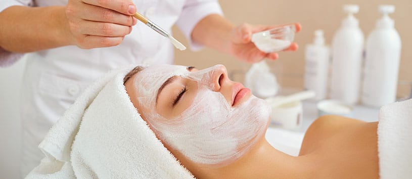 Woman receiving a facial treatment.