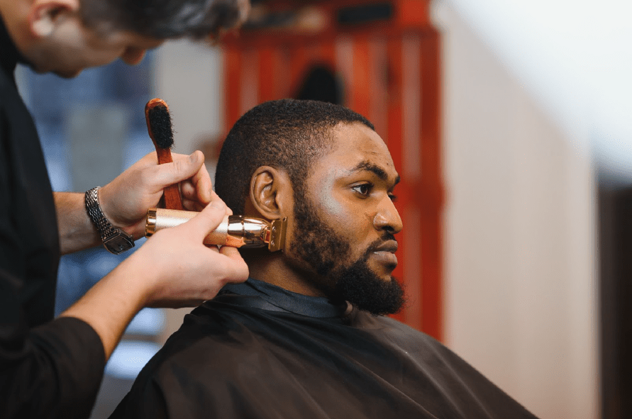 Man receiving a facial shave to his beard.